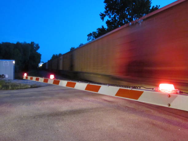 istock Railroad Crossing Gate fast freight blurred speed 2200236763