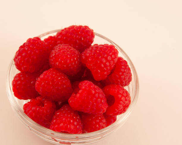 Raspberry and blackberry on black mirror. Side view. High resolution photo.  Selective focus. Shallow depth of field.