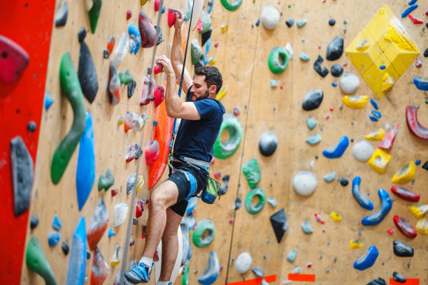 istock Man Engaged in Indoor Rock Climbing Activity 2200237080