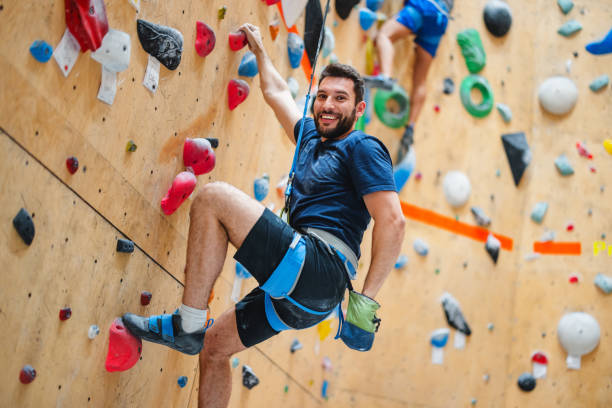 istock Smiling Man Climbing at Indoor Climbing Center 2200237085