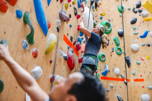 istock Adults Climbing Indoor Wall at Gym for Challenge 2200237119