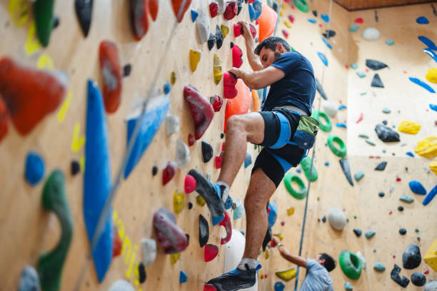 istock Man Bouldering on Indoor Climbing Wall 2200237123