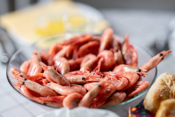 fresh cooked shrimp in a glass bowl on a dining table