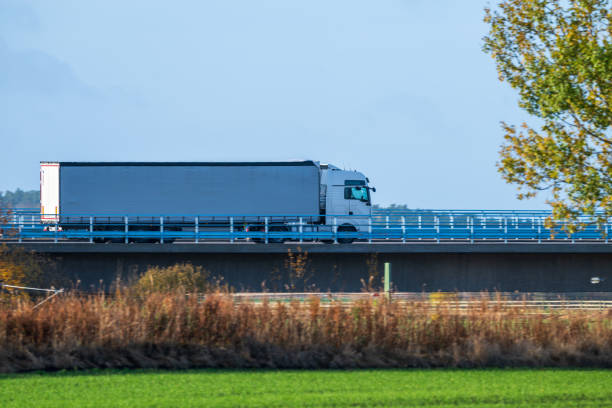 istock white truck driving on a bridge. 2200240144