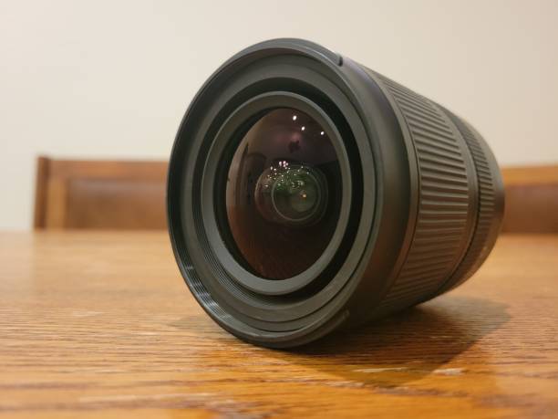 istock A beautifully designed camera lens resting gracefully on a polished wooden surface 2200240240