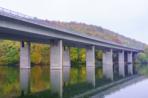 istock A panoramic view of a motorway bridge spanning Lake Seilersee in Iserlohn, Germany, surrounded by vibrant autumn foliage. The  contrast between modern infrastructure and the natural beauty of the season. 2200240488