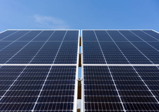 istock Low angle view of big industrial solar panel on background of blue sky 2200247420
