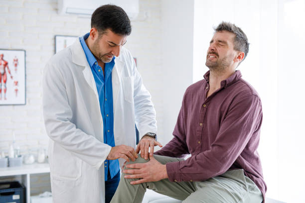 istock Man is visiting his physiotherapist, about his knee pain 2200249314