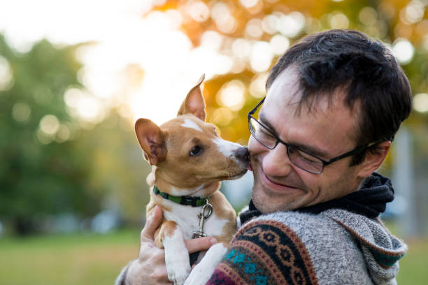 istock Puppy Licking Her Owner's Cheek Affectionately 2200249559
