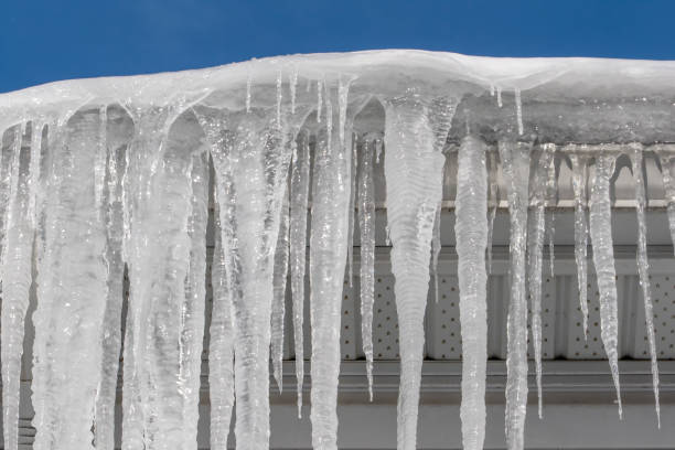 istock Icicles Hanging Over a Roof on a Sunny Day 2200249750