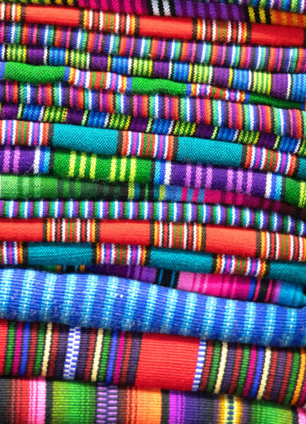 Full frame , colourful abstract of hand woven Mayan fabrics stacked on display. Panajachel, Lake Atitlan, Guatemala.