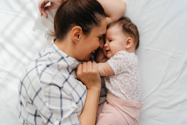 istock Mother's Love: A Sweet Cuddle with Her Baby Girl 2200252819
