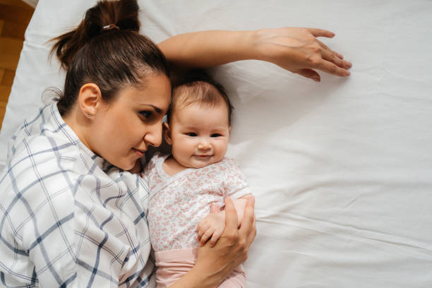 istock Mother's Love: A Sweet Cuddle with Her Baby Girl 2200252969