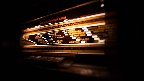 Close-up of a vintage radio tuner with illuminated frequency markings.