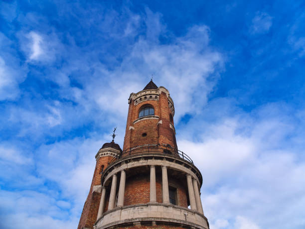 Architectural view of ornate brick Gardos tower  in Zemun with columns and domes against cloudy blue sky. Belgrade, Belgrade