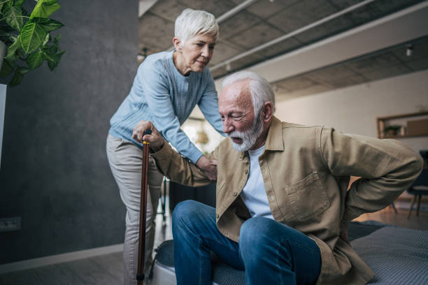 istock Senior man experiencing back pain while wife helping him 2200257952