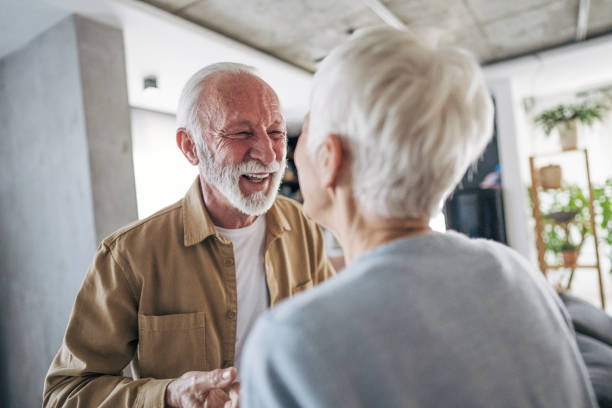 istock Happy senior couple smiling and interacting at home 2200258240