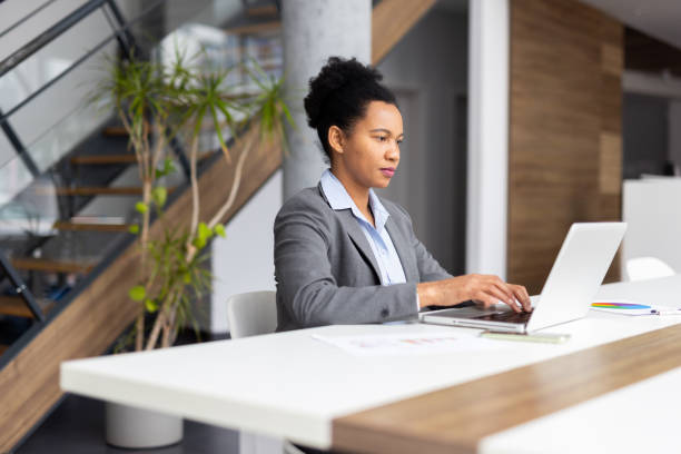 istock Experienced African American executive focused on her laptop in an office setting 2200259167