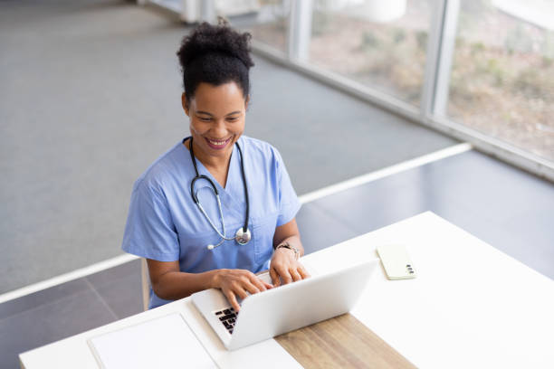 istock Confident African American nurse typing medical notes on a laptop 2200261799