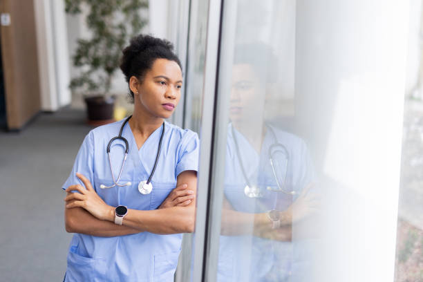 istock Experienced African American nurse posing with a warm expression 2200261901