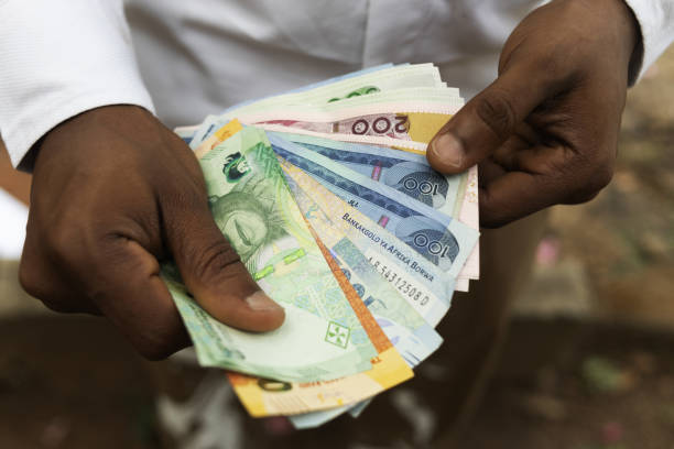 istock A person holding different african currency notes 2200263275