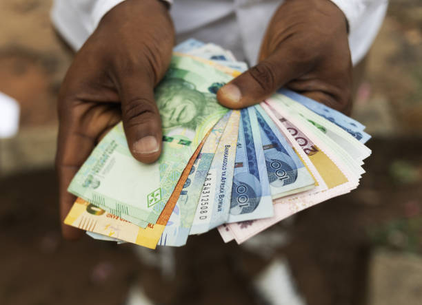 istock A person holding different african currency notes 2200263278