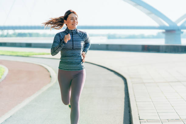 istock Happy sportswoman running 2200264766