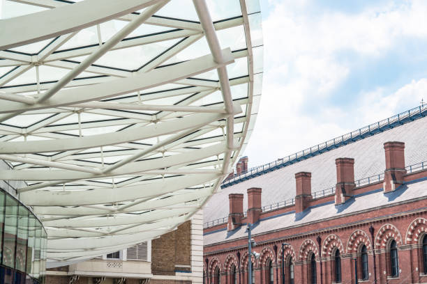 Modern glass and steel canopy juxtaposed against the victorian architecture of st. Pancras renaissance hotel