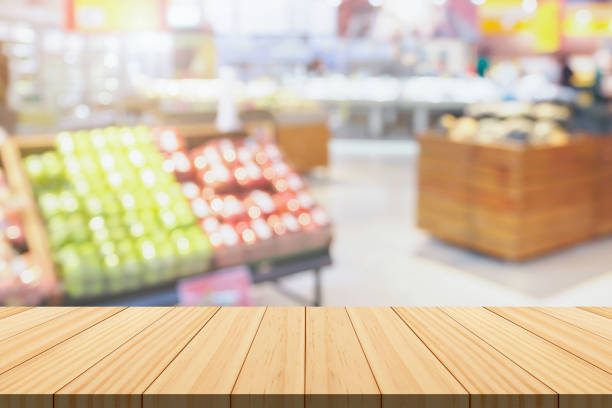 istock Empty wood table top with supermarket blurred background for product display 2200268105
