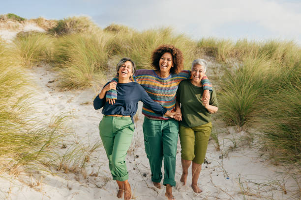 istock Shared laughter and seaside fun for women embracing midlife adventures 2200268691