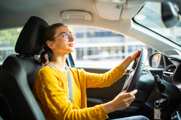 istock Young woman driving a car 2200269517