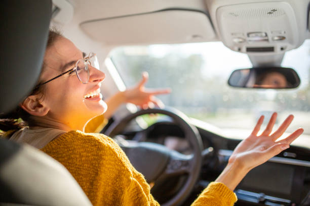 istock Annoyed young woman driver stuck in a traffic jam 2200269530