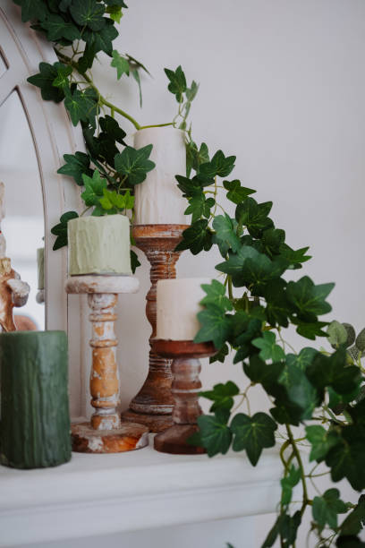istock Elegant candle arrangement with greenery decor on a mantle 2200270042