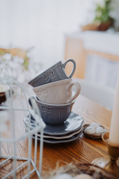 istock Stacked ceramic cups on a wooden table in a cozy living space 2200270073
