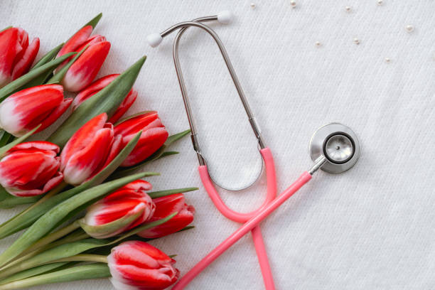 istock Pink stethoscope beside red tulips on a light background during springtime, Cancer Awareness Month 2200270593