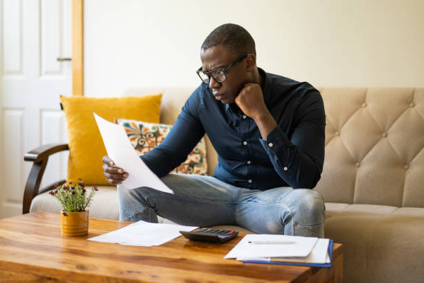 istock Low income man checking his home finances 2200271545