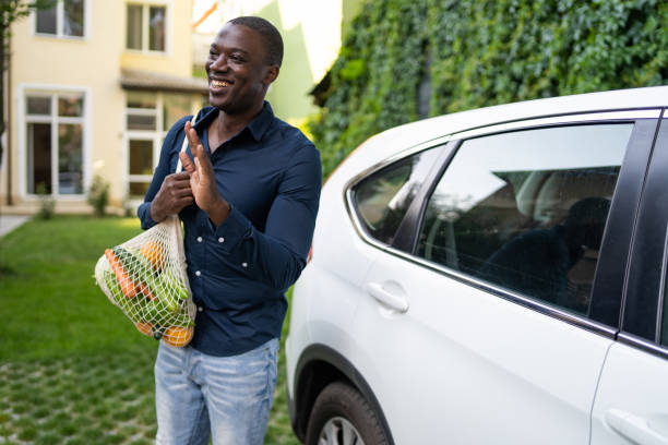 istock Smiling man arriving home with the vegetable shopping 2200271593