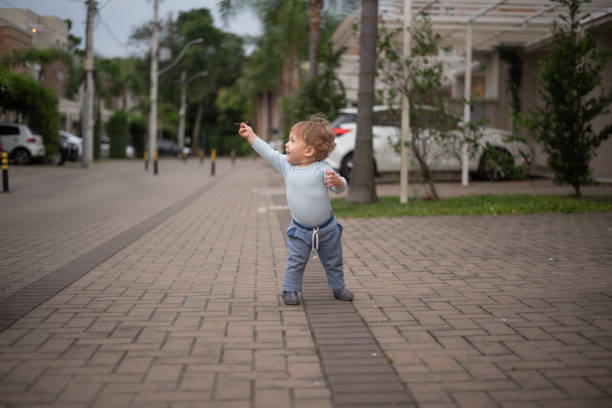 Baby offering a branch to someone