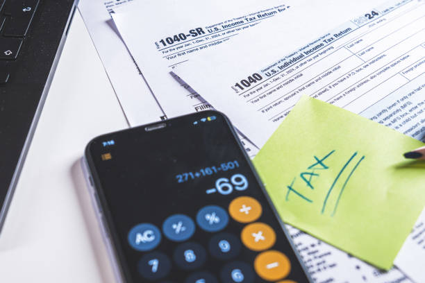istock Accountant calculating taxes using calculator app on smartphone 2200275320