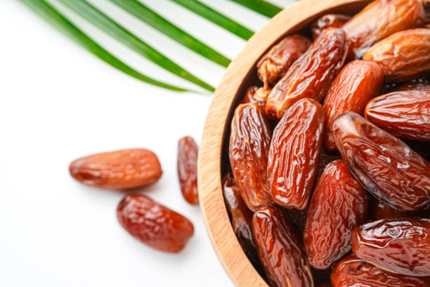 istock Dates fruit tunisia, Tunisian honey dates, in bowl isolated on white background 2200280776