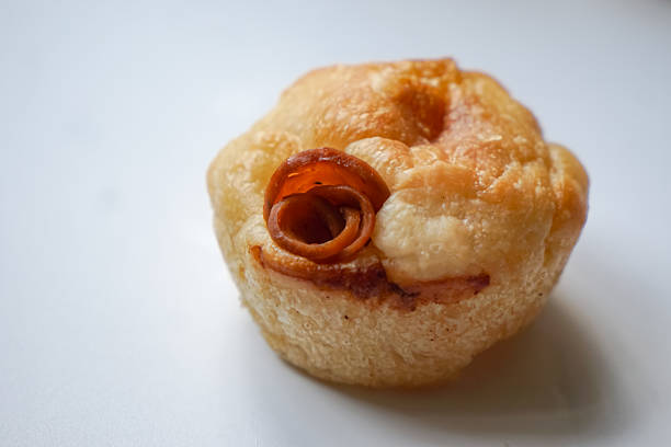 Close up view of Sourdough Focaccia Bread Muffins with pepperoni on white background in selective focus.