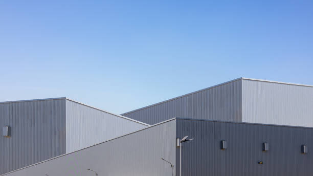 istock Factory industry, Warehouse Construction in Geometric Modern Design, Modern Industrial Warehouse Exterior on a Sunny Day, Backdrop Wall Metal Corrugated Steel Surface Pattern. 2200284094