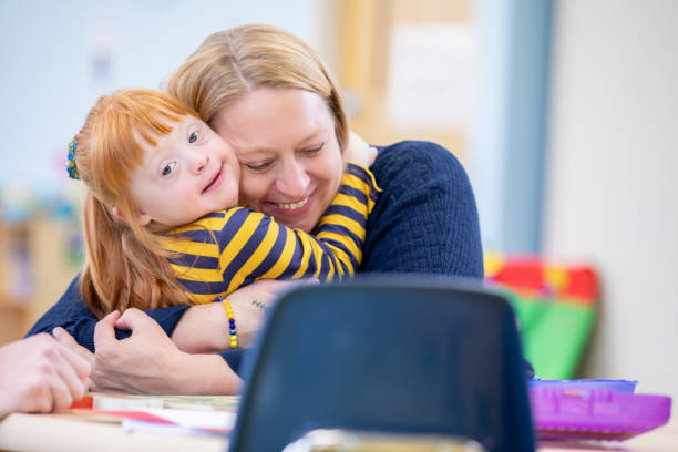 istock A mother and her young daughter with Down Syndrome hug each other affectionately. 2200285187