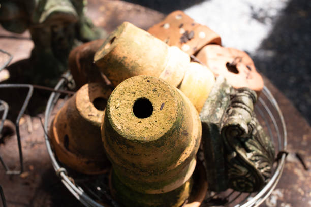 istock Old plant pot bottom with drainage holes, round shape, old plant pot background image. 2200286306