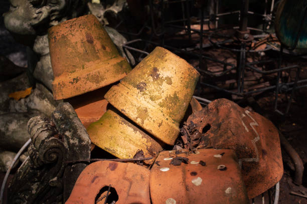 Old plant pots and garden trash. Blurred and dark background image.