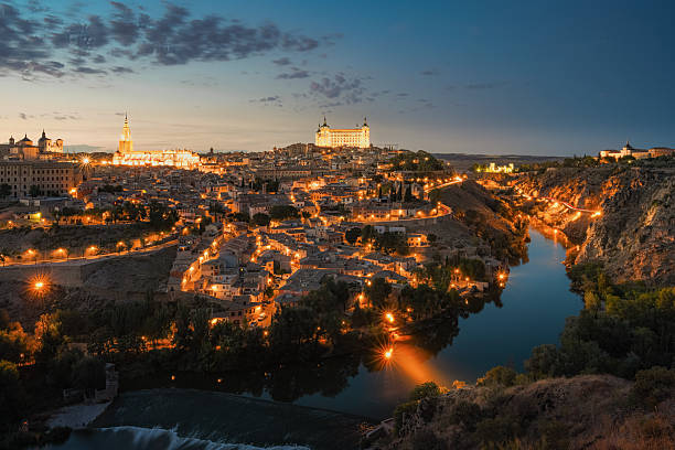 Toledo skyline featuring its medieval cathedral at night (Spain).
