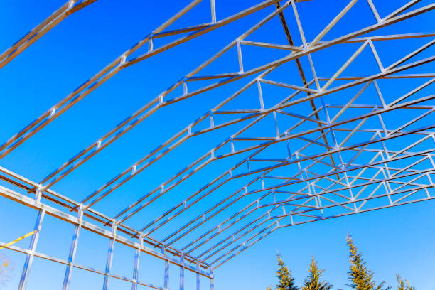 istock Construction of a metal frame structure under a clear blue sky in a rural area during daylight 2200293842