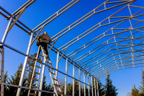 istock Construction worker assembles metal frame of a building on a clear sunny day 2200293853