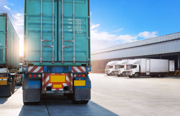 istock Semi Trailer Trucks on The Parking Lot at Warehouse. Trucks Loading Goods at Dock Warehouse. Distribution Warehouse Center. Shipping Container. Freight Truck Logistics, Cargo Transportation. 2200305711
