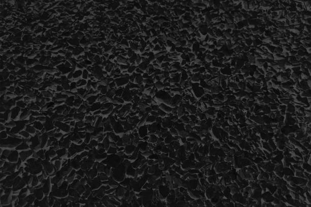 istock Black coloured rough textured asphalt road like grunge vector abstract grainy frothy horizontal background that is blank and empty and has froth or foam pattern design all over 2200308275